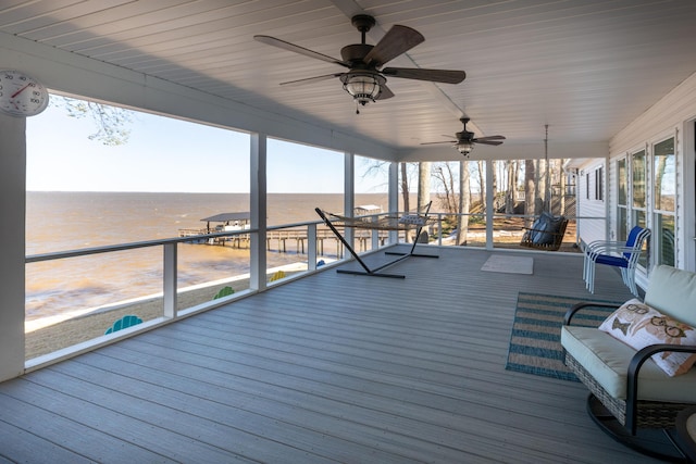 wooden deck featuring a water view and a ceiling fan