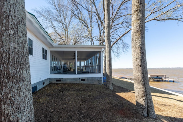 exterior space with crawl space, a sunroom, and a ceiling fan