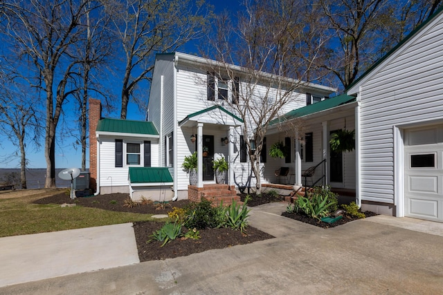 view of front of property with a chimney and metal roof