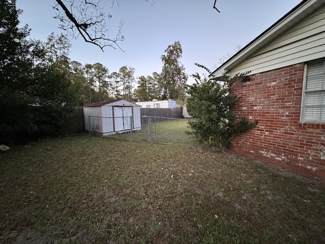 view of yard featuring an outdoor structure, a storage shed, and fence