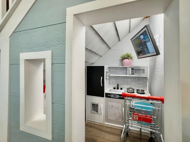 interior space featuring hardwood / wood-style flooring and vaulted ceiling