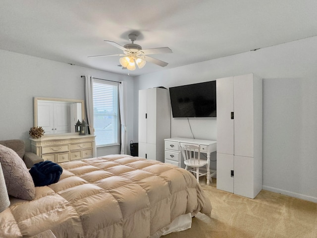 bedroom with ceiling fan and light carpet