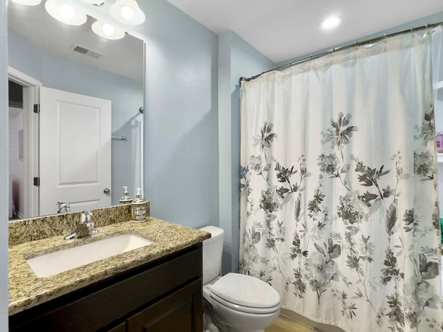 bathroom with vanity, toilet, and curtained shower