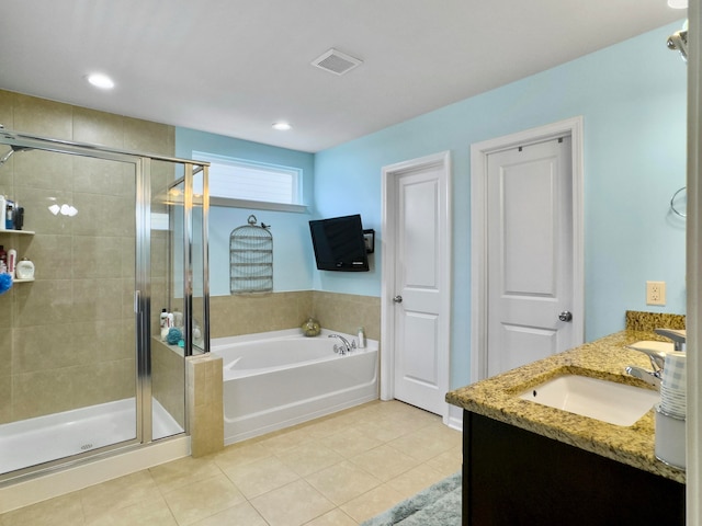 bathroom with tile patterned floors, independent shower and bath, and vanity