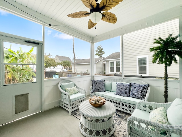 sunroom featuring ceiling fan