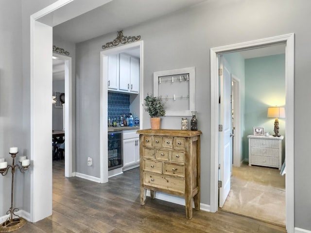 corridor featuring beverage cooler and dark wood-type flooring