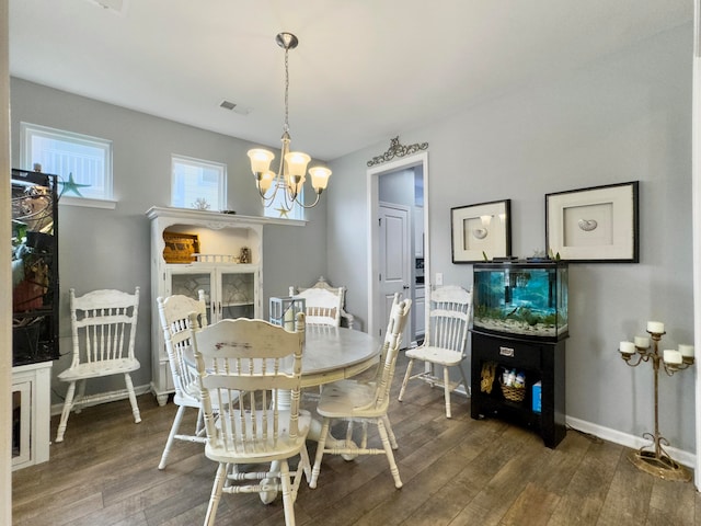 dining space featuring a chandelier and dark hardwood / wood-style floors