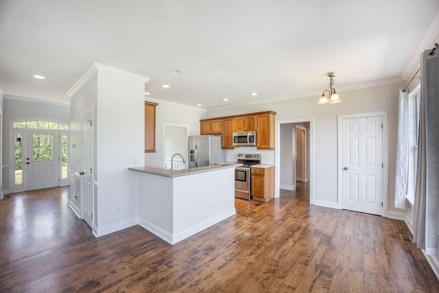 1713 Pimlico Blvd, Moncks Corner, SC 29461 - kitchen with appliances with stainless steel finishes, brown cabinets, a peninsula, a chandelier, and dark wood-style flooring