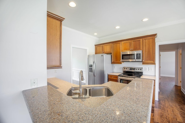 1713 Pimlico Blvd, Moncks Corner, SC 29461 - kitchen with stainless steel appliances, a sink, ornamental molding, brown cabinetry, and recessed lighting