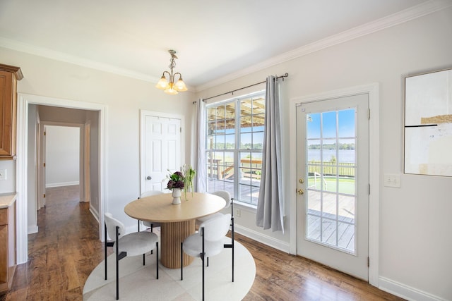 1713 Pimlico Blvd, Moncks Corner, SC 29461 - dining room featuring a chandelier, crown molding, wood finished floors, baseboards, and a water view