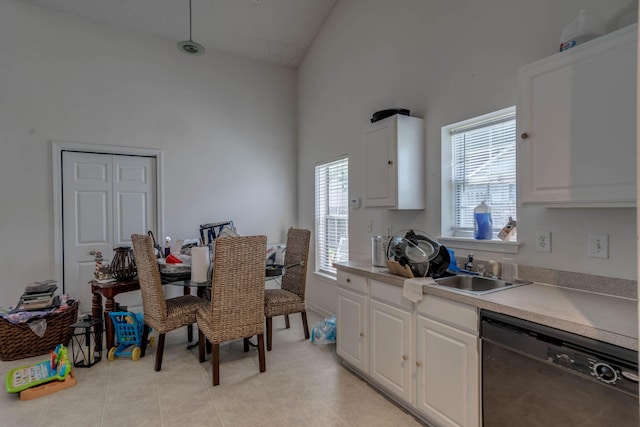 kitchen featuring black dishwasher, white cabinets, high vaulted ceiling, and plenty of natural light