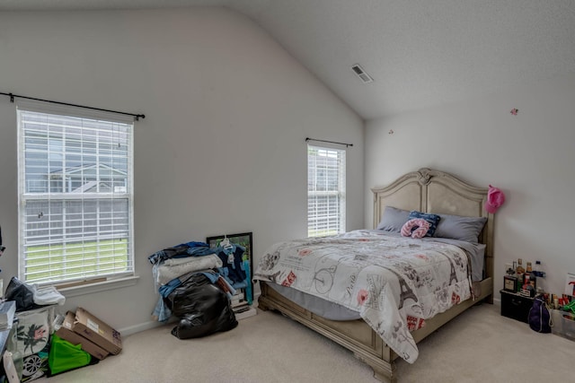 carpeted bedroom featuring high vaulted ceiling and visible vents