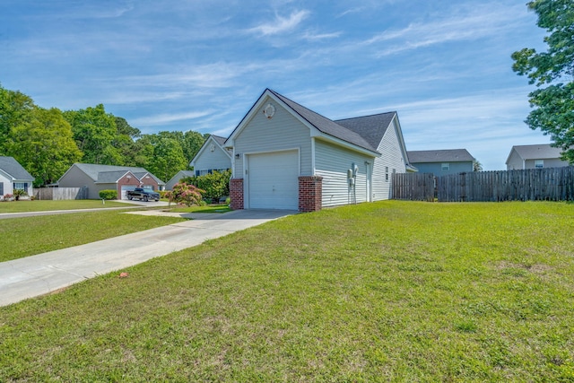 view of home's exterior with fence, brick siding, driveway, a yard, and a garage