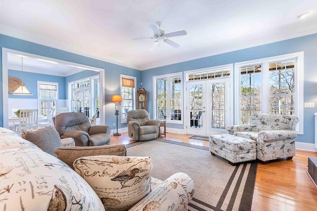 interior space with access to exterior, french doors, ornamental molding, and light wood finished floors