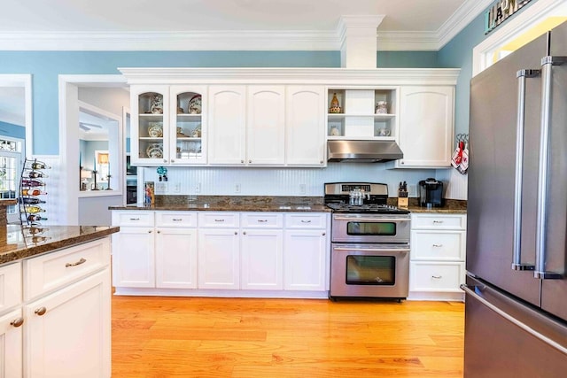 kitchen featuring stainless steel appliances, white cabinets, light wood-style flooring, and under cabinet range hood