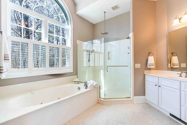 bathroom featuring vanity, visible vents, a bath, tile patterned floors, and a stall shower