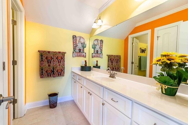 bathroom featuring baseboards, vaulted ceiling, vanity, and tile patterned floors