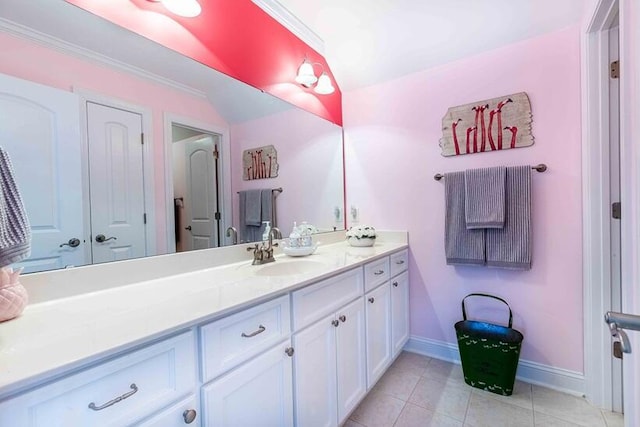 bathroom with tile patterned flooring, baseboards, ornamental molding, and vanity