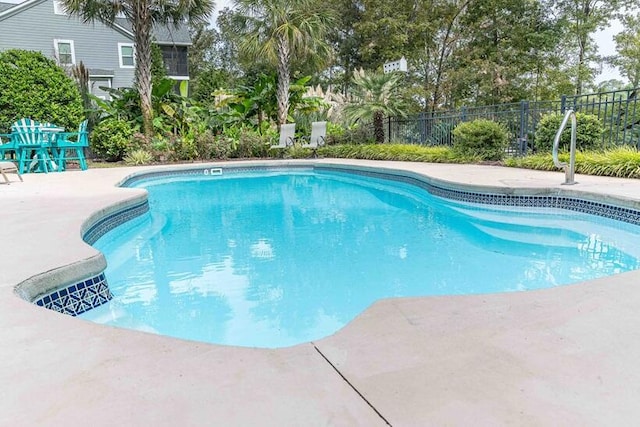 view of swimming pool featuring a fenced in pool, a patio area, and fence