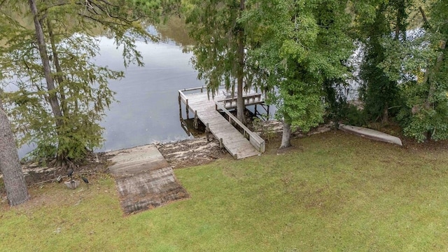 dock area featuring a yard and a water view