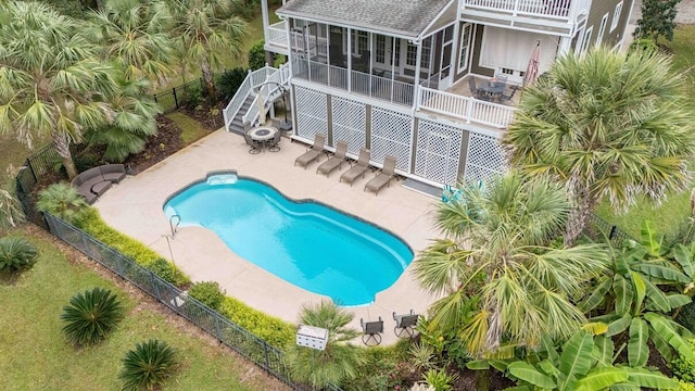 view of pool with a fenced in pool, stairway, a sunroom, a patio area, and fence