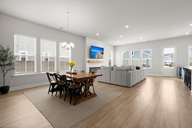 238 Bird Song Path, Summerville, SC 29485 - dining space featuring light wood finished floors, baseboards, a chandelier, a glass covered fireplace, and recessed lighting