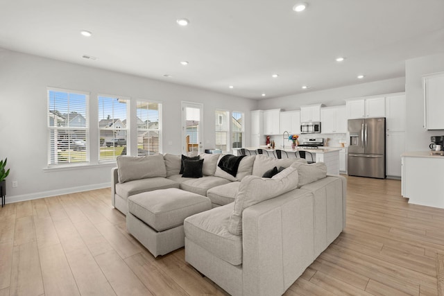 238 Bird Song Path, Summerville, SC 29485 - living area featuring light wood-type flooring, recessed lighting, and baseboards