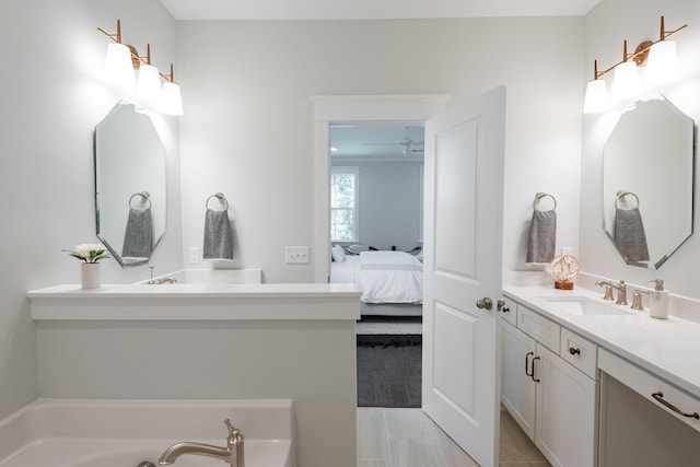 full bathroom with a tub to relax in, vanity, and ensuite bathroom