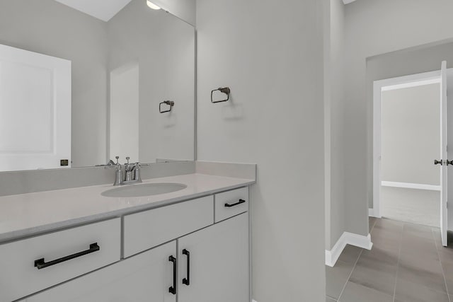 bathroom with tile patterned flooring, vanity, and baseboards