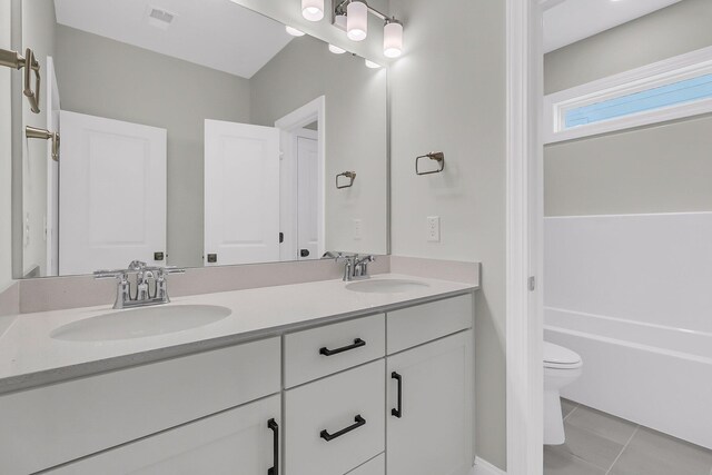 bathroom featuring tile patterned flooring, visible vents, a sink, and toilet