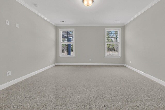 carpeted empty room featuring baseboards, visible vents, and ornamental molding