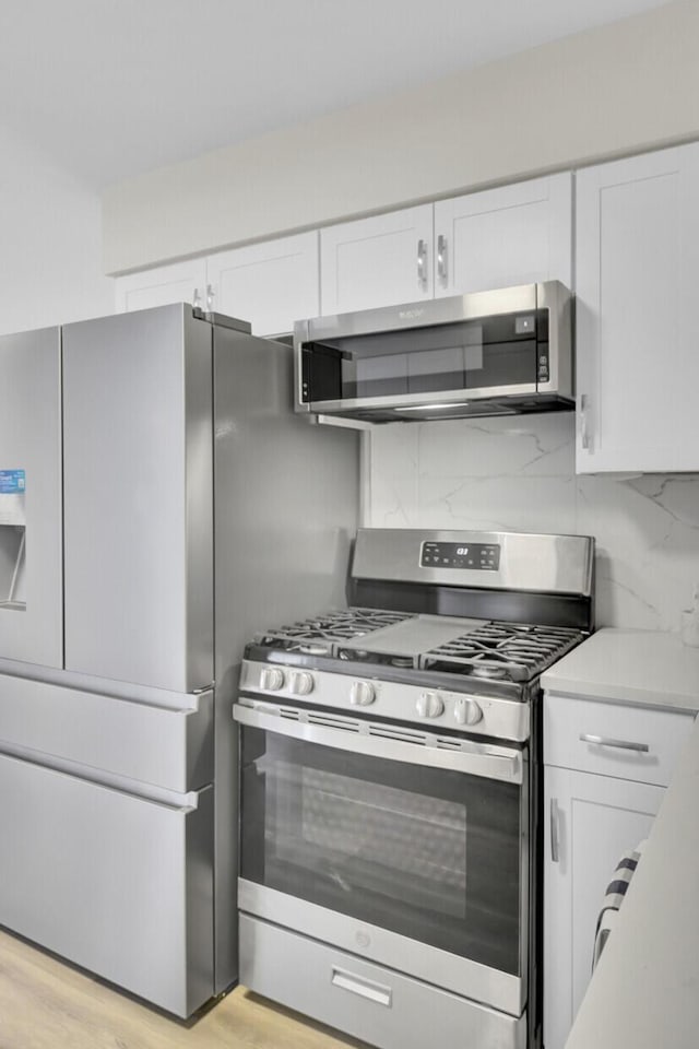 kitchen featuring appliances with stainless steel finishes and white cabinetry