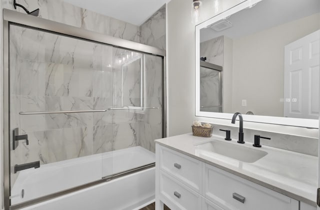 full bathroom featuring shower / bath combination with glass door and vanity