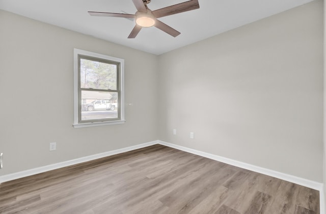 unfurnished room featuring ceiling fan, baseboards, and wood finished floors