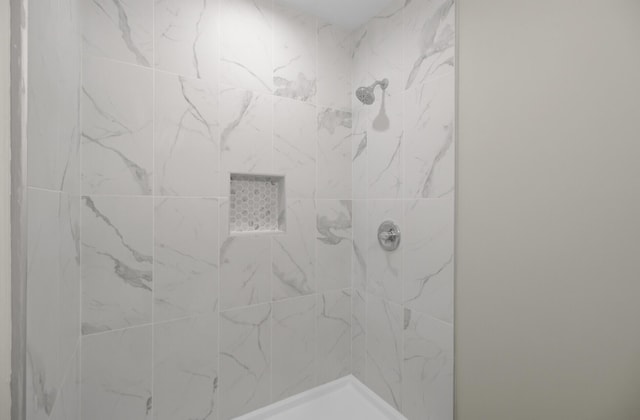 full bathroom with a tile shower