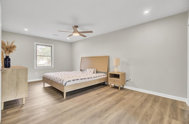 bedroom with light wood finished floors, baseboards, and recessed lighting