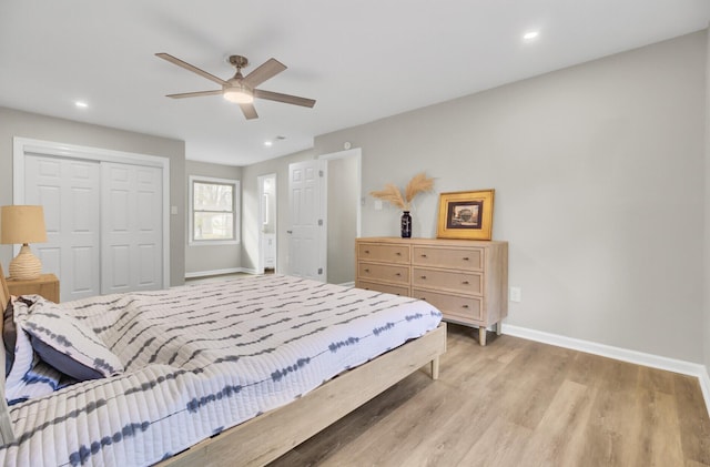 bedroom featuring recessed lighting, a closet, light wood-type flooring, and baseboards