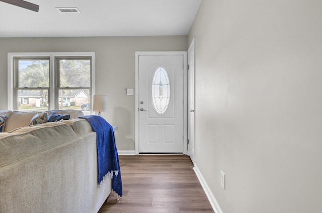 foyer with visible vents, baseboards, and dark wood-type flooring