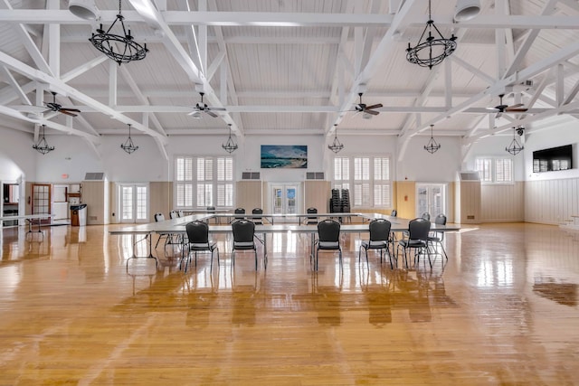 misc room with beam ceiling, high vaulted ceiling, plenty of natural light, and light hardwood / wood-style floors