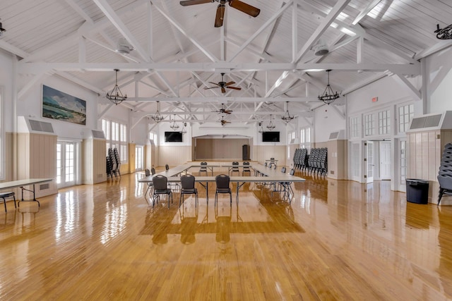 miscellaneous room featuring light hardwood / wood-style floors, high vaulted ceiling, and beam ceiling