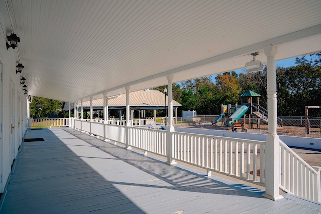 wooden terrace featuring a playground