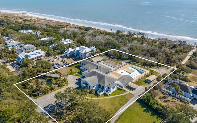 birds eye view of property featuring a water view and a beach view