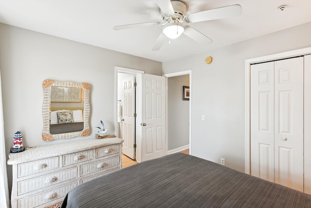 unfurnished bedroom with ceiling fan, light wood-type flooring, and a closet