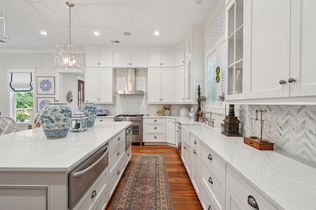 28 Robert Mills Cir, Mount Pleasant, SC 29464 - kitchen with wall chimney exhaust hood, stainless steel appliances, a warming drawer, light stone countertops, and white cabinets