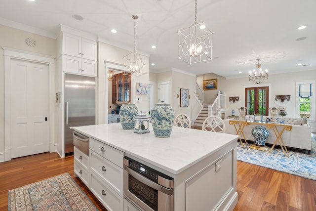 28 Robert Mills Cir, Mount Pleasant, SC 29464 - kitchen with a chandelier, built in appliances, a warming drawer, wood finished floors, and crown molding