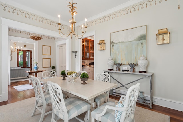 28 Robert Mills Cir, Mount Pleasant, SC 29464 - dining area with a chandelier, wood finished floors, baseboards, and crown molding