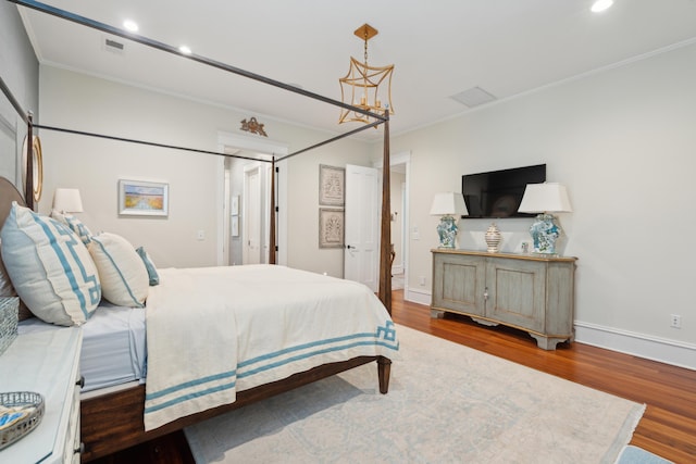 28 Robert Mills Cir, Mount Pleasant, SC 29464 - bedroom with wood finished floors, crown molding, recessed lighting, a chandelier, and baseboards