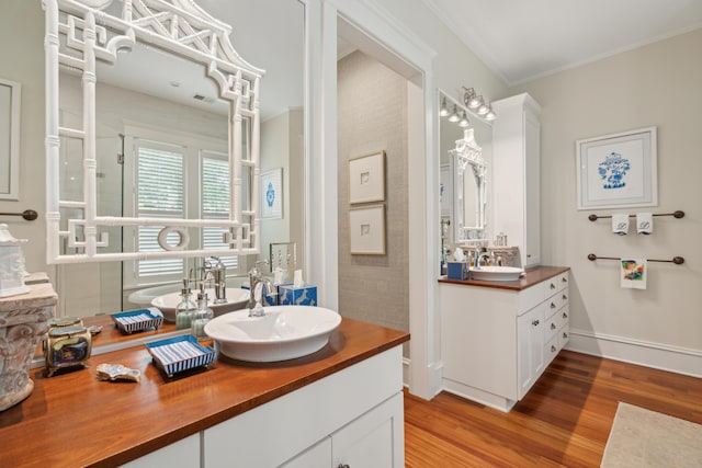 28 Robert Mills Cir, Mount Pleasant, SC 29464 - bathroom with wood finished floors, vanity, baseboards, a shower with shower door, and ornamental molding