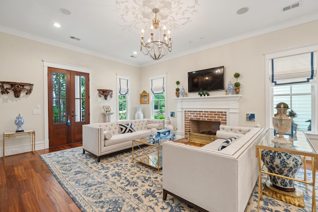 28 Robert Mills Cir, Mount Pleasant, SC 29464 - living room featuring wood finished floors, a chandelier, recessed lighting, ornamental molding, and a brick fireplace