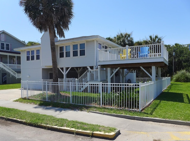 1001 Palmetto Blvd, Edisto Island, SC 29438 - view of front facade featuring stairway, a fenced front yard, and a chimney